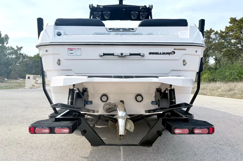 Slide: The Image of Rear view of 2023 Supra SE 550 boat with SwellSurf system on trailer. - 13