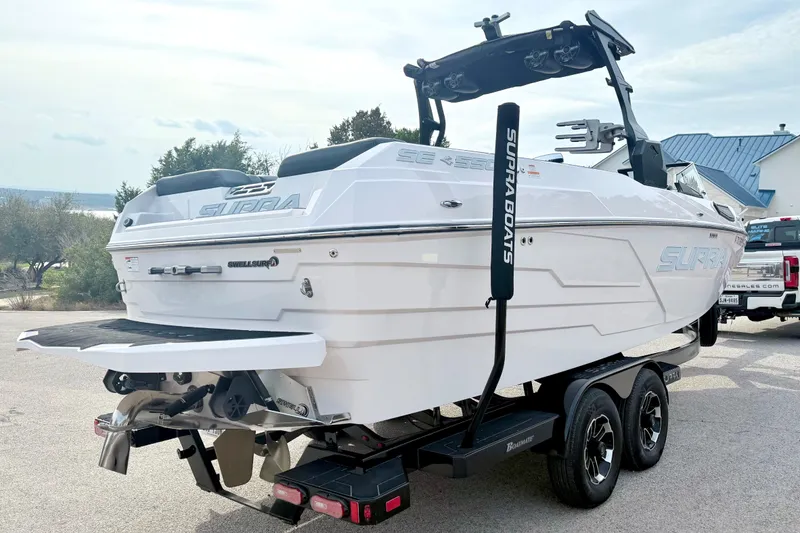Slide: The Image of 2023 Supra SE 550 boat on trailer, showcasing sleek design and modern features. - 14
