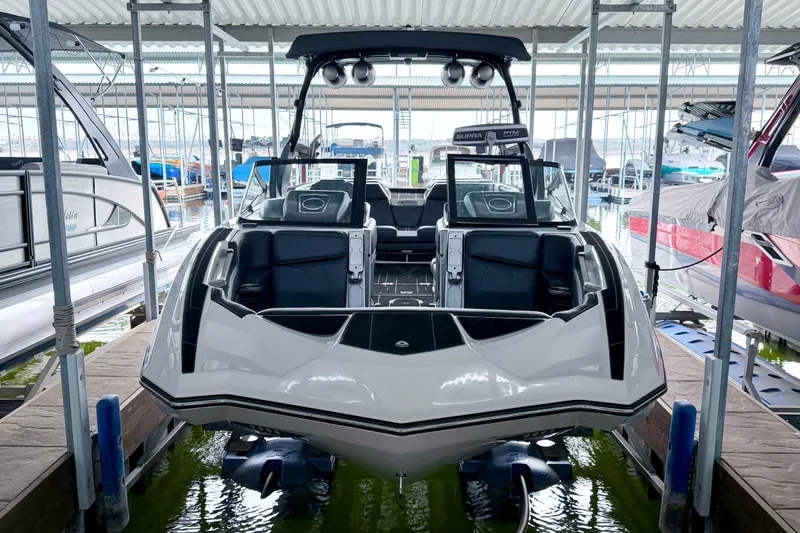 Slide: The Image of 2023 Supra SE 550 boat docked in a marina, showcasing sleek design and modern features. - 21
