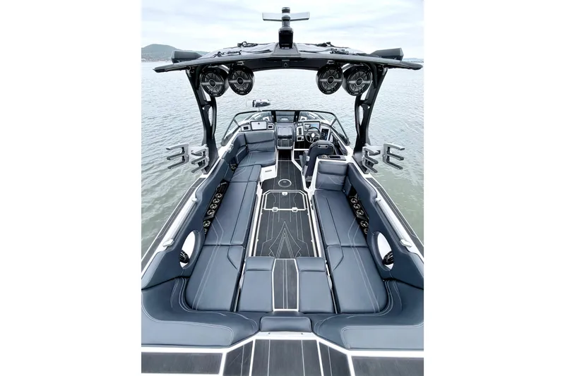 Slide: The Image of 2023 Supra SE 550 boat interior with luxurious seating and advanced audio system on the water. - 27
