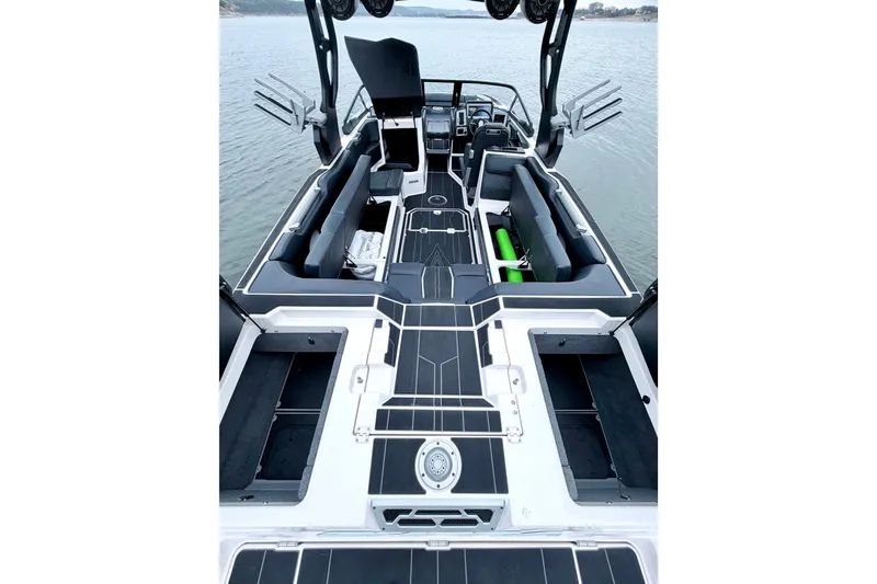 Slide: The Image of 2023 Supra SE 550 boat interior with sleek seating and modern design on the water. - 28