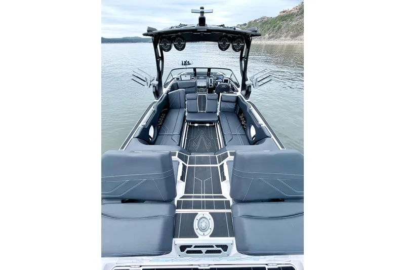 Slide: The Image of 2023 Supra SE 550 boat interior with luxurious seating on a calm lake. - 29