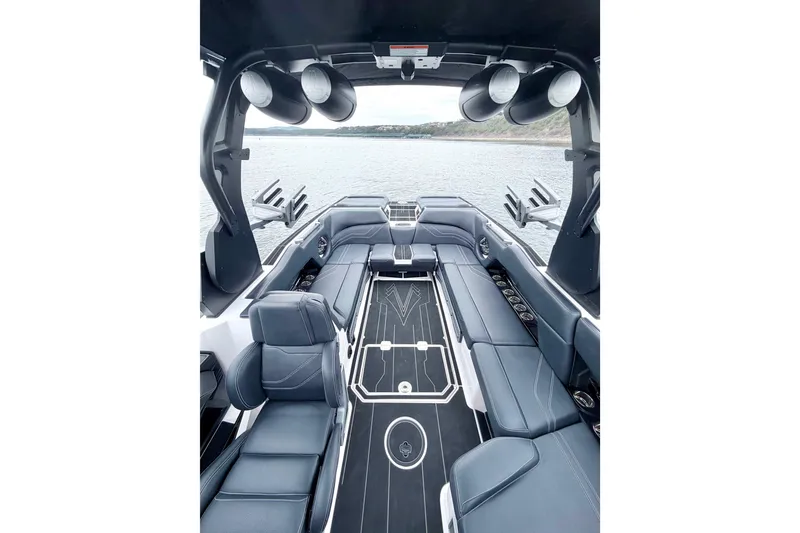 Slide: The Image of 2023 Supra SE 550 boat interior with luxurious seating and modern design on a serene lake. - 31