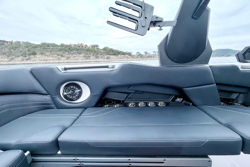 Slide: The Image of 2023 Supra SE 550 boat interior with sleek seating and speaker system. - 32