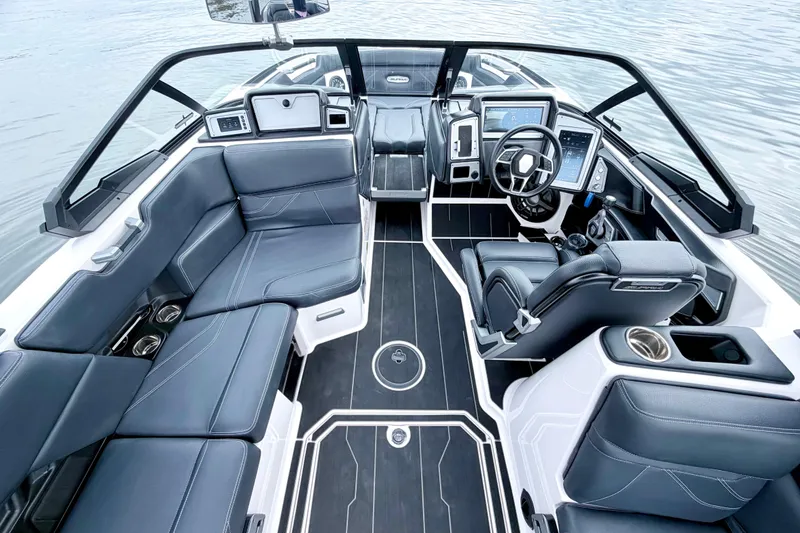 Slide: The Image of 2023 Supra SE 550 boat interior with sleek black seating and modern dashboard. - 33