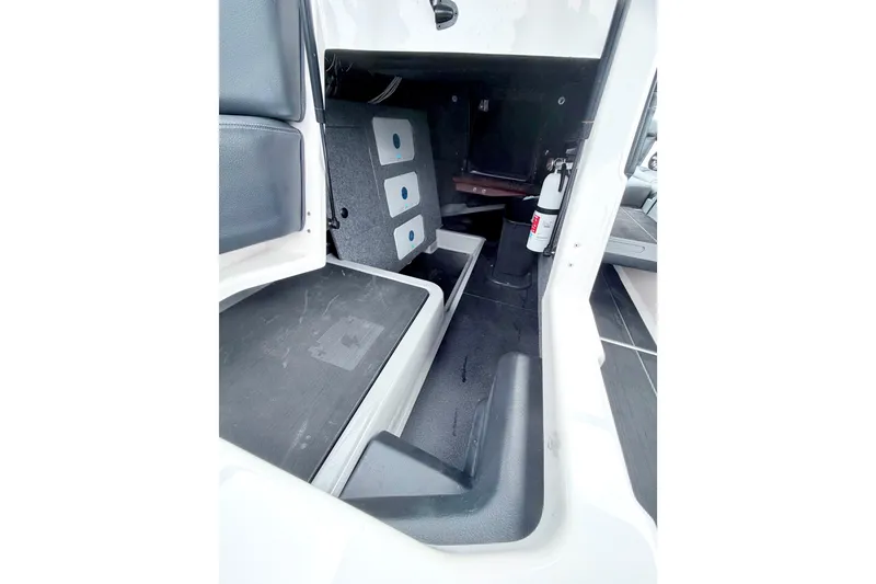 Slide: The Image of 2023 Supra SE 550 interior storage compartment with fire extinguisher and seating area. - 36