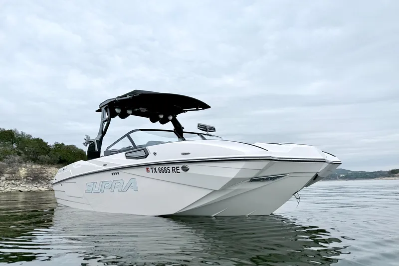 Slide: The Image of 2023 Supra SE 550 boat on calm water, showcasing sleek design and modern features. - 4