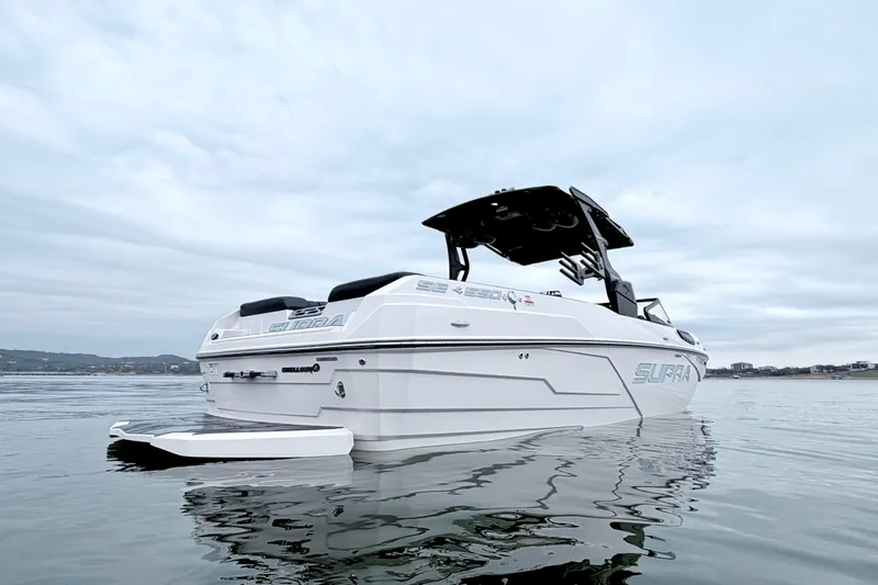 Slide: The Image of 2023 Supra SE 550 boat on calm water, showcasing sleek design and modern features. - 5