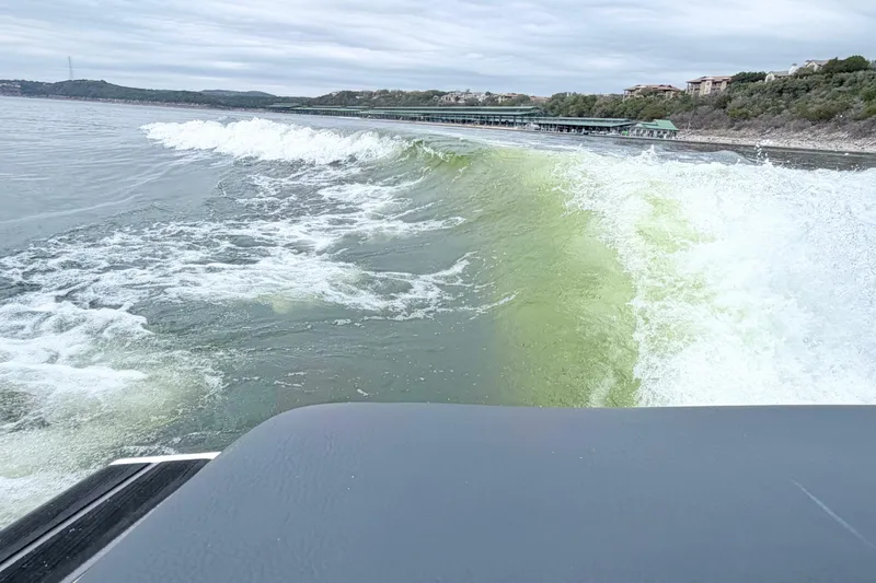 Slide: The Image of 2023 Supra SE 550 creating waves on a scenic lake. - 8