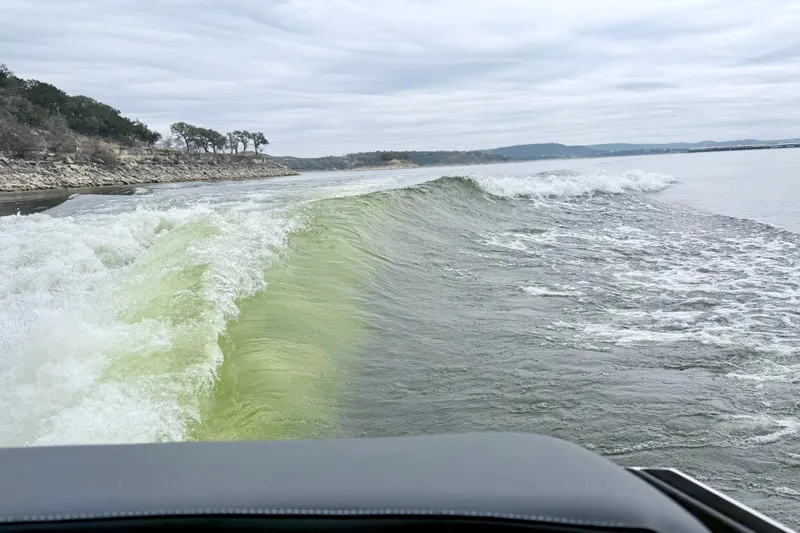 Slide: The Image of Waves created by 2023 Supra SE 550 boat on a cloudy lake. - 9