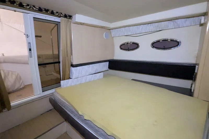 Slide: The Image of Interior cabin of 2000 Carver 404 Cockpit Motor Yacht with bed and portholes. - 10