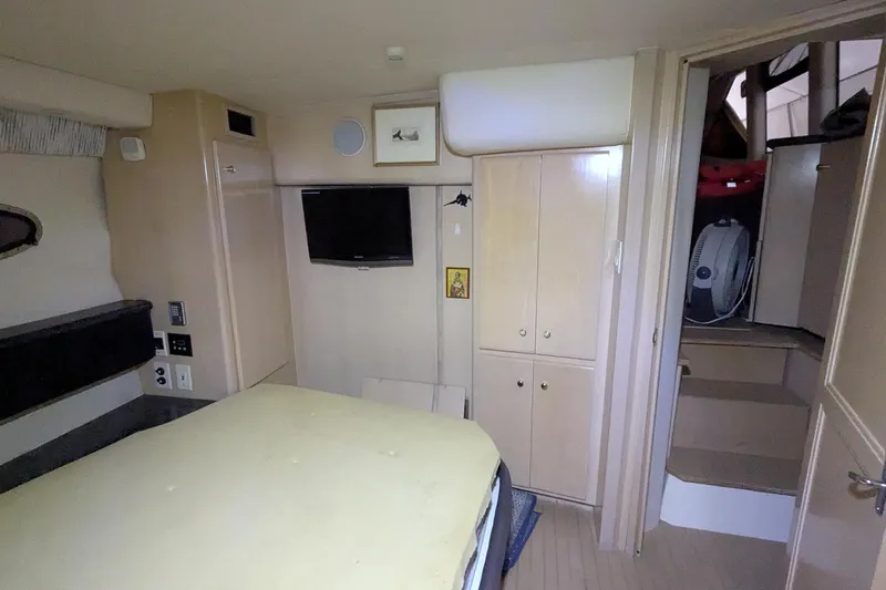 Slide: The Image of Interior of 2000 Carver 404 Cockpit Motor Yacht with bed, TV, and storage cabinets. - 16