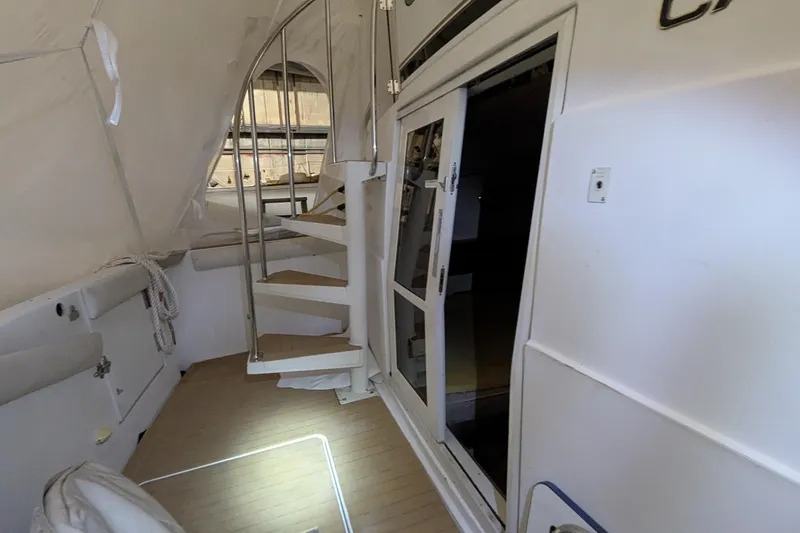 Slide: The Image of Interior of 2000 Carver 404 Cockpit Motor Yacht with spiral staircase and sliding door. - 17