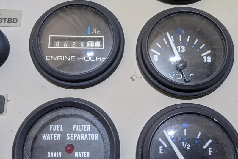 Slide: The Image of Instrument panel of 2000 Carver 404 Cockpit Motor Yacht showing engine hours and voltmeter. - 18