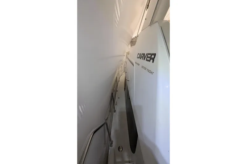 Slide: The Image of 2000 Carver 404 Cockpit Motor Yacht side view with sleek design and railing. - 19