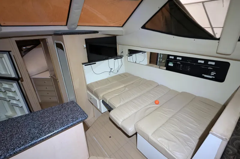 Slide: The Image of Interior of 2000 Carver 404 Cockpit Motor Yacht with beige seating and modern amenities. - 20