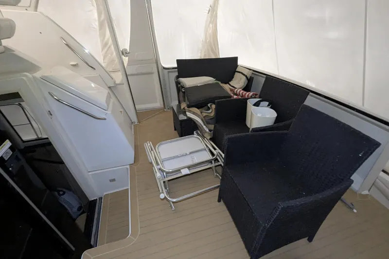 Slide: The Image of 2000 Carver 404 Cockpit Motor Yacht interior with seating and storage. - 8