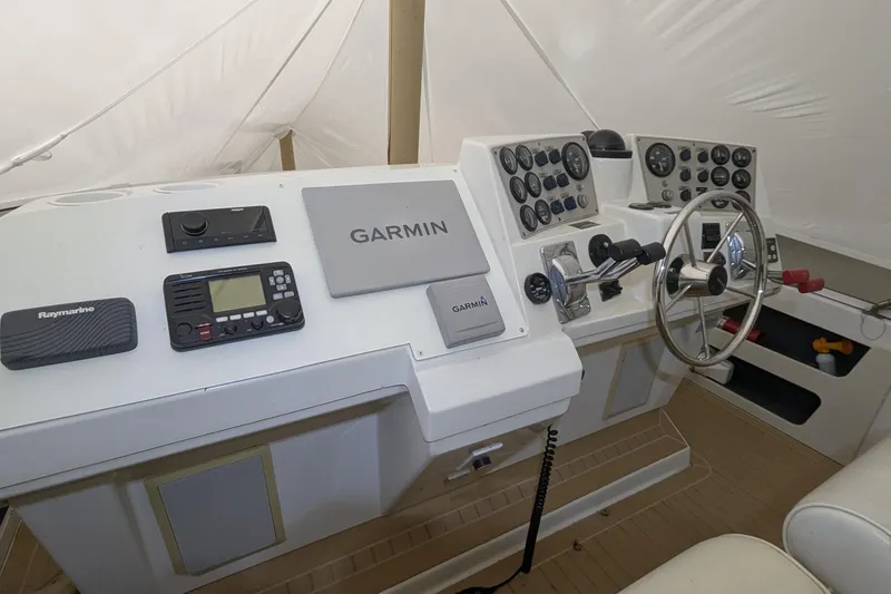 Slide: The Image of Cockpit of 2000 Carver 404 Motor Yacht with Garmin and Raymarine navigation systems. - 12