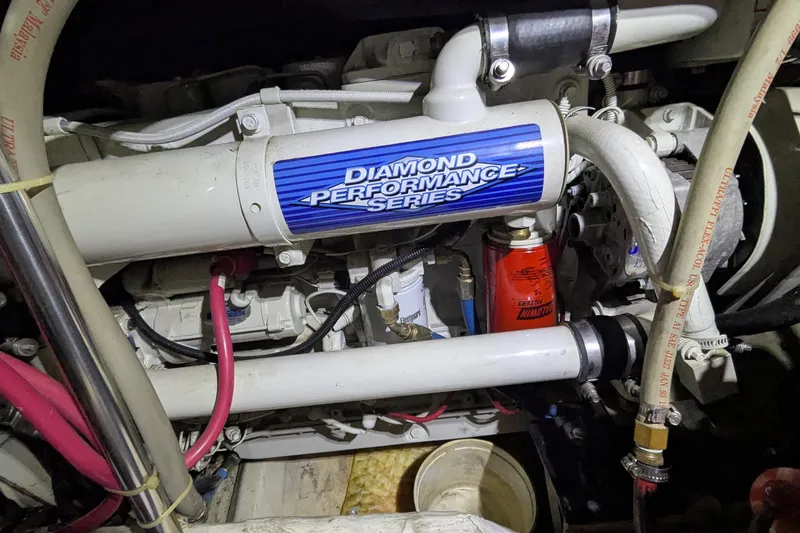 Slide: The Image of Engine compartment of 2000 Carver 404 Cockpit Motor Yacht, featuring Diamond Performance Series components. - 13