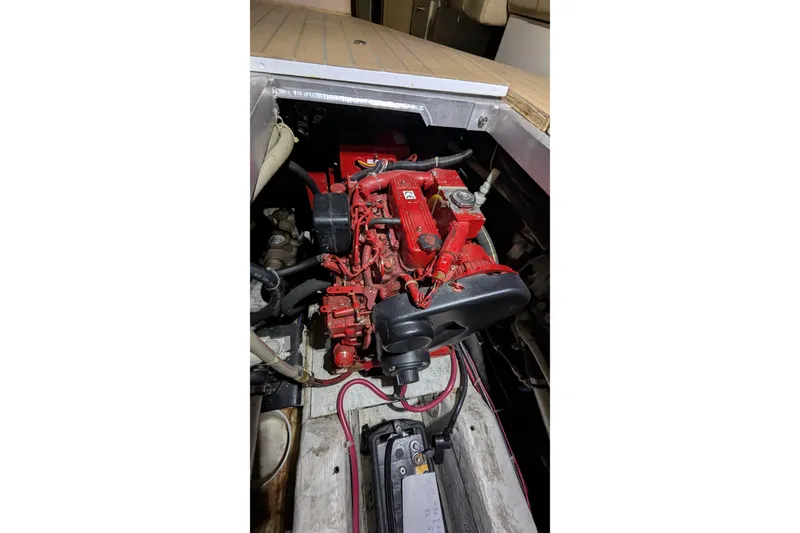 Slide: The Image of Engine compartment of 2000 Carver 404 Cockpit Motor Yacht, featuring a red engine. - 15