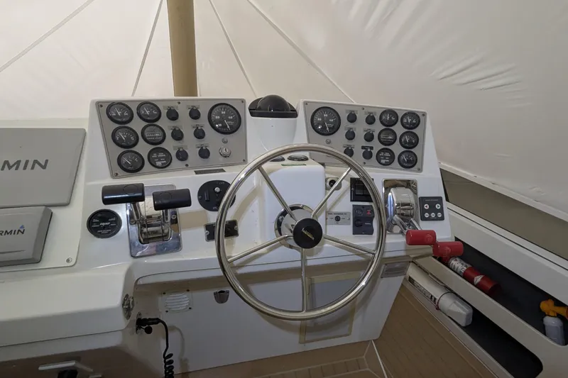 Slide: The Image of Helm of 2000 Carver 404 Cockpit Motor Yacht with steering wheel and control panel. - 4