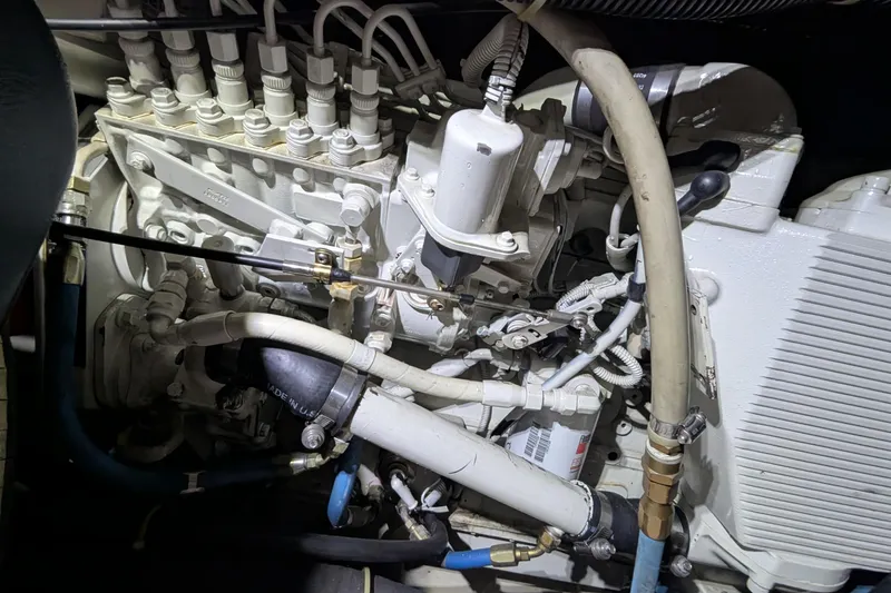 Slide: The Image of Engine compartment of a 2000 Carver 404 Cockpit Motor Yacht, showcasing intricate mechanical components. - 9