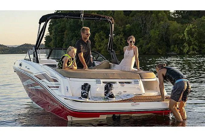 Slide: The Image of 2024 Bayliner VR6 Bowrider I/O cockpit with steering wheel and beige seating. - 3