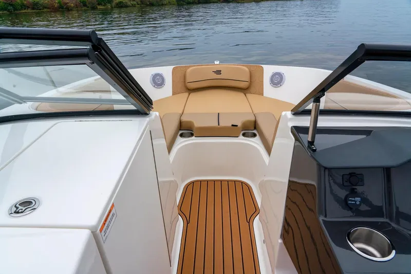 Slide: The Image of 2024 Bayliner VR6 Bowrider I/O storage compartment, open and empty, with white interior. - 6