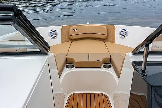 Slide: The Image of 2024 Bayliner VR6 Bowrider I/O with beige seating and canopy, parked outdoors. - 7