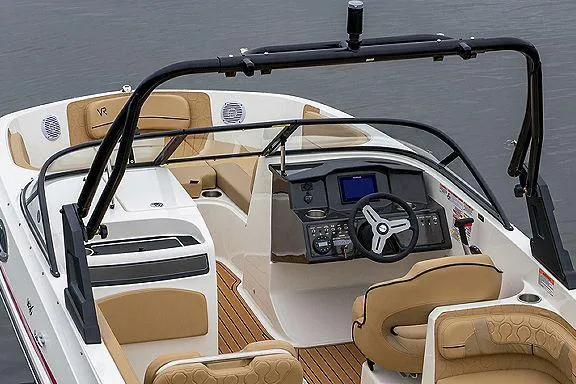 Slide: The Image of 2024 Bayliner VR6 Bowrider I/O with tan seating, displayed outdoors at a dealership. - 8