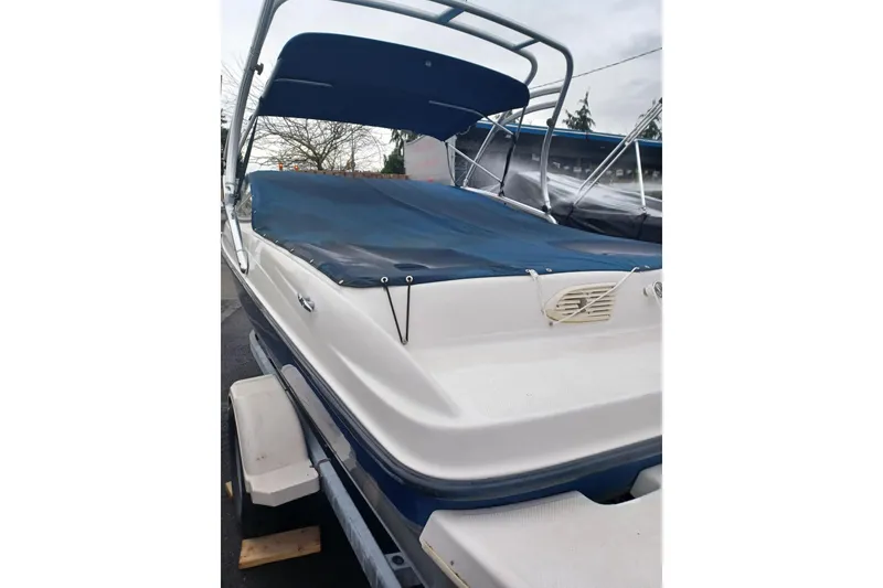 Slide: The Image of 2004 Bayliner 205 boat with blue cover and canopy on trailer. - 3