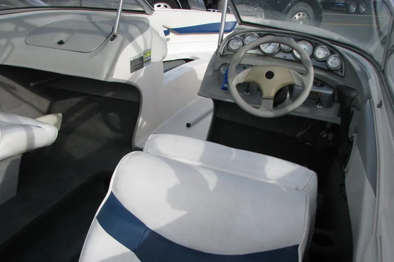 Slide: The Image of 2004 Bayliner 205 boat interior with steering wheel and dashboard gauges. - 4