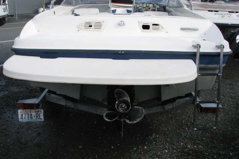 Slide: The Image of Rear view of 2004 Bayliner 205 boat on trailer, showing propeller and swim platform. - 5