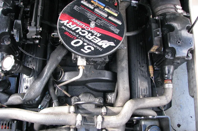 Slide: The Image of 2004 Bayliner 205 engine, featuring a 5.0L MerCruiser motor with visible components and hoses. - 6