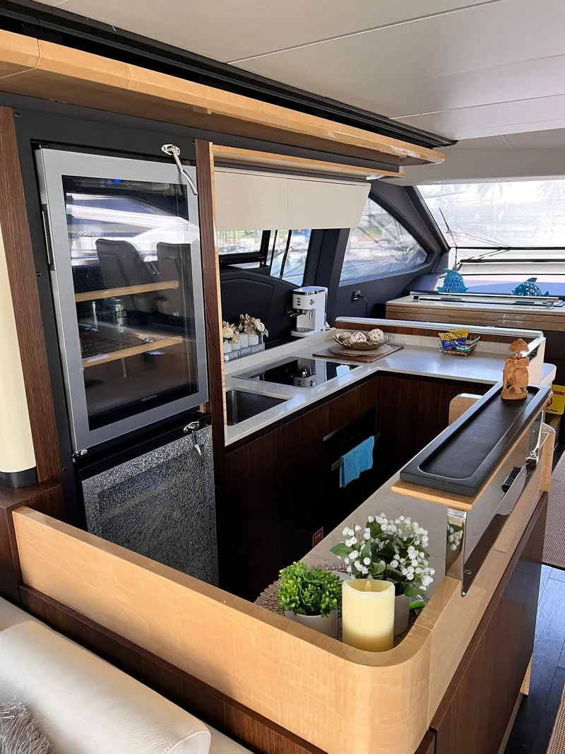 Slide: The Image of Luxurious interior of a 2016 Azimut Fly 72 yacht, featuring a modern kitchen design. - 17