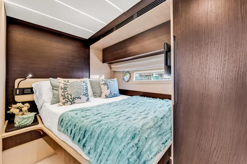 Slide: The Image of Luxurious bedroom interior of 2016 Azimut Fly 72 yacht with elegant bedding and wood accents. - 29