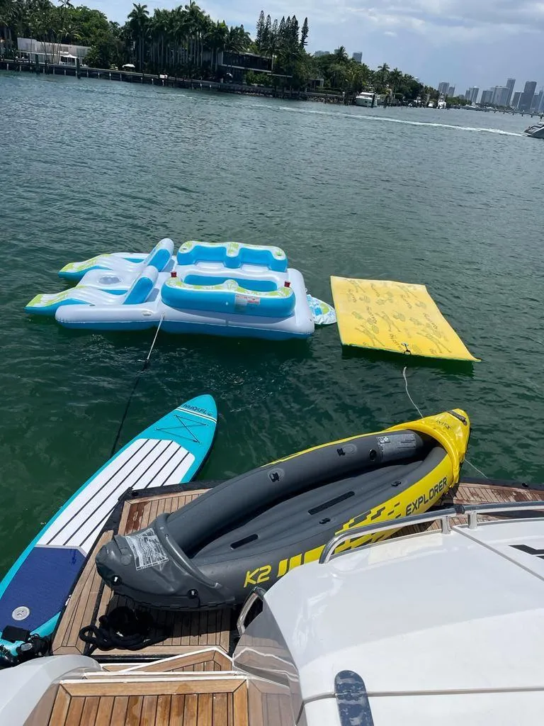 Slide: The Image of Azimut Fly 72 yacht with paddleboard, inflatable raft, and floating mat on water. - 45
