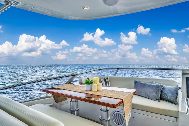 Slide: The Image of Luxurious Azimut Fly 72 yacht deck with ocean view, featuring elegant seating and table setup. - 8