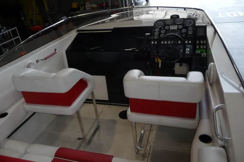 Slide: The Image of 1989 Baja 280 Sportfish boat interior with red and white seating and control panel. - 14