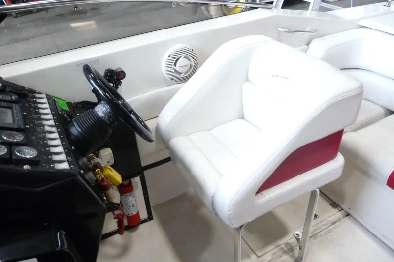 Slide: The Image of 1989 Baja 280 Sportfish boat interior with steering wheel and white seating. - 15