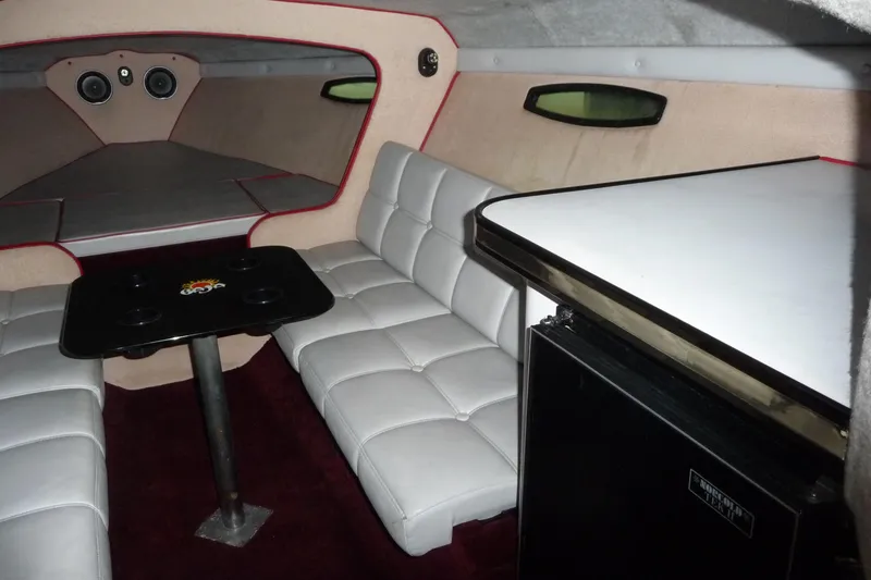 Slide: The Image of Interior of a 1989 Baja 280 Sportfish boat with white seating and table. - 19