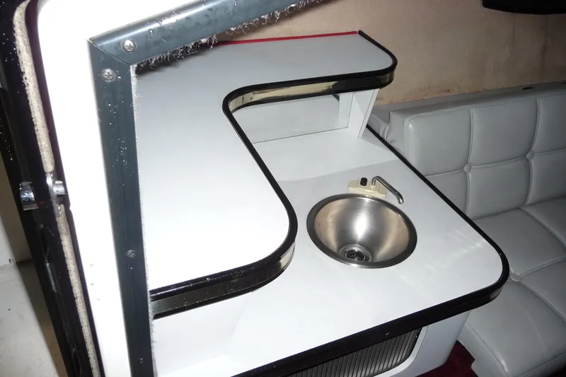 Slide: The Image of 1989 Baja 280 Sportfish interior with compact sink and seating area. - 20