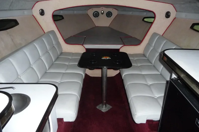 Slide: The Image of 1989 Baja 280 Sportfish cabin interior with white seating and table. - 21