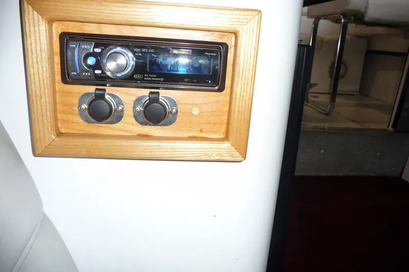 Slide: The Image of 1989 Baja 280 Sportfish stereo system with wooden frame and dual switches. - 25