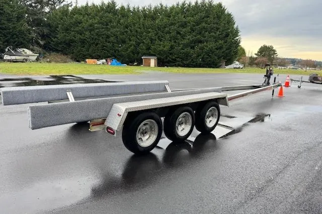 Slide: The Image of Triple-axle boat trailer on wet pavement, designed for 1989 Baja 280 Sportfish. - 35