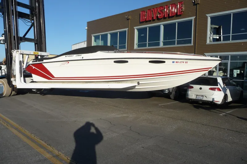 Slide: The Image of 1989 Baja 280 Sportfish boat lifted by forklift outside Bayside building. - 5