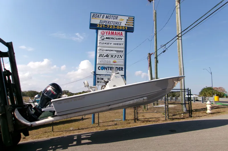Slide: The Image of 2026 Key West 210 Bay Reef boat displayed at dealership with Yamaha motor. - 1