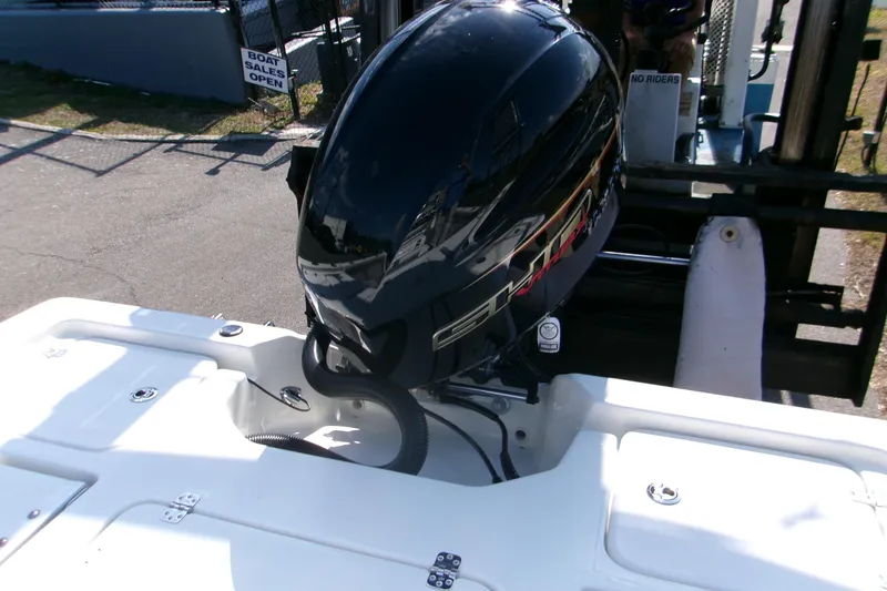 Slide: The Image of 2026 Key West 210 Bay Reef boat engine displayed at a sales lot. - 10