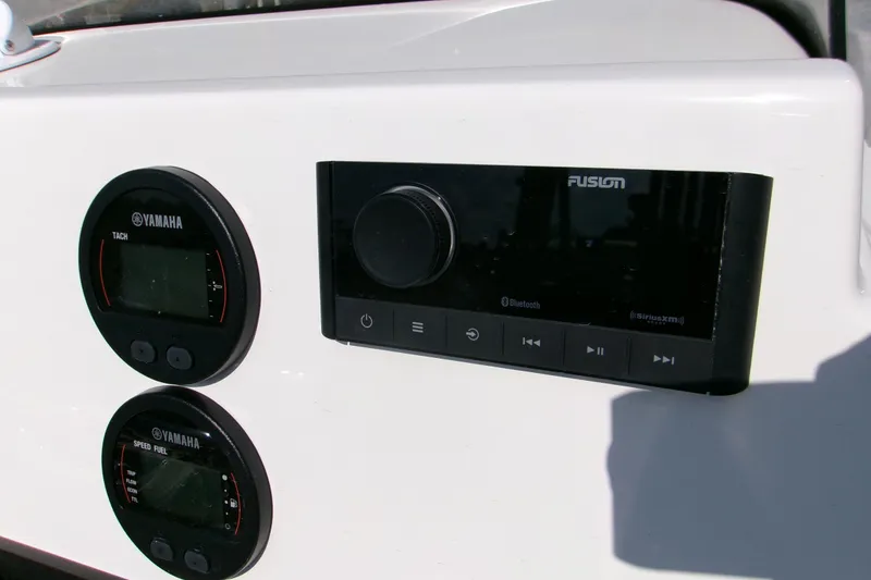 Slide: The Image of Control panel of 2026 Key West 210 Bay Reef with Yamaha gauges and Fusion audio system. - 16