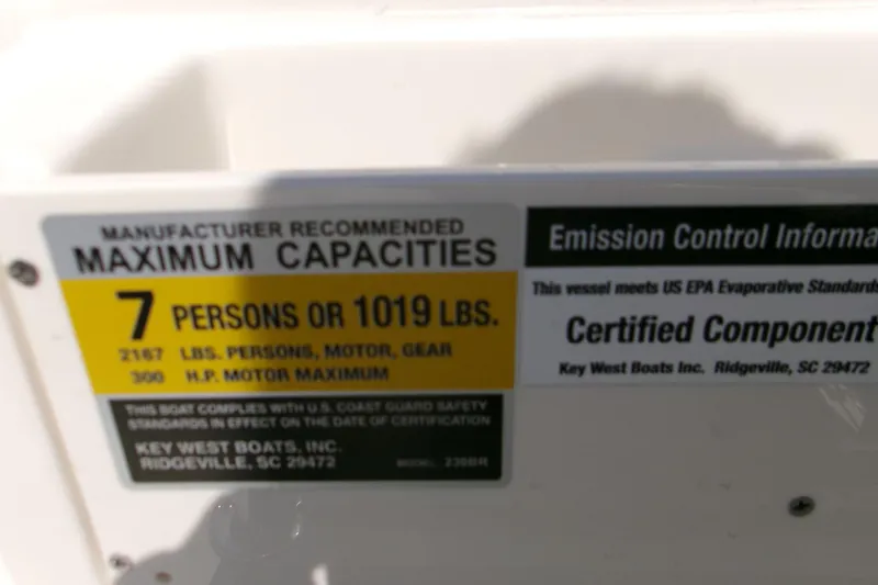 Slide: The Image of Key West 210 Bay Reef 2026 capacity label: 7 persons or 1019 lbs, 300 HP motor max. - 19